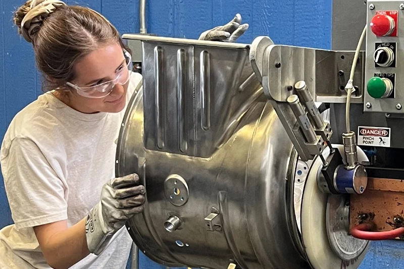 uhi team member working on aerospace part